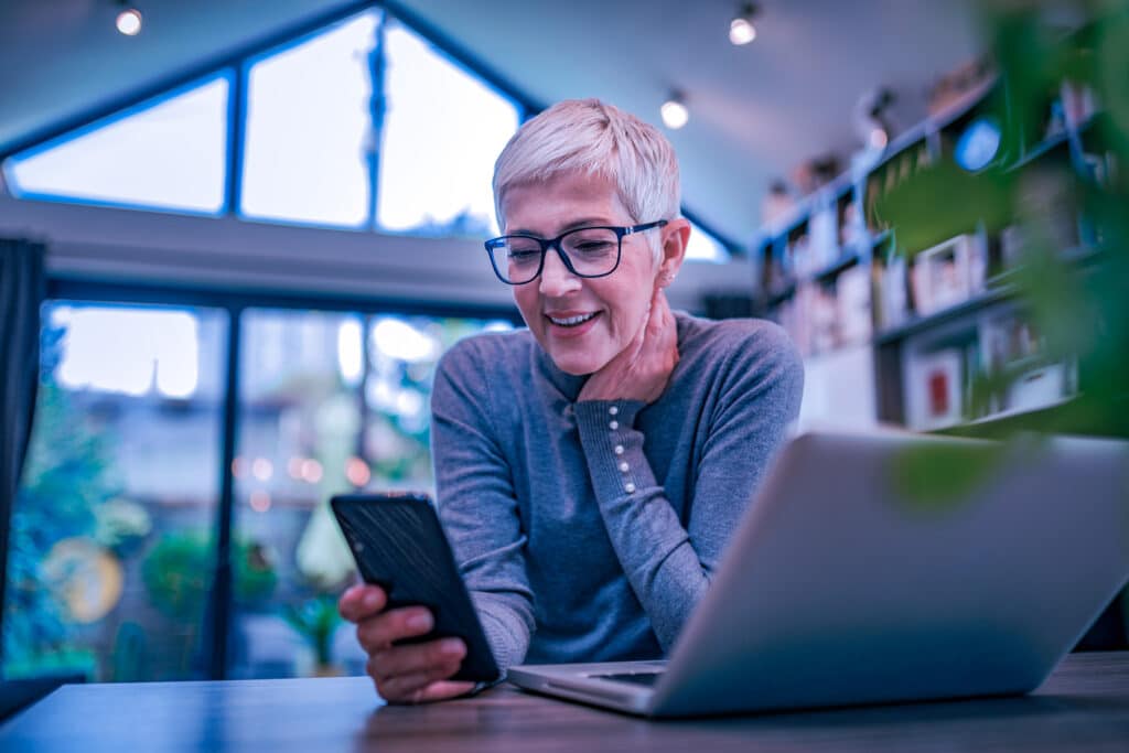 A women happy to work from home stress free knowing she is safe and educated on cybersecurity
