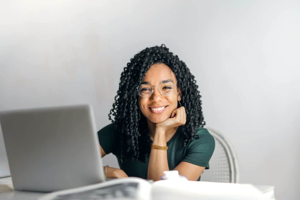 Women sitting behind her computer, happy she sent out proper emails